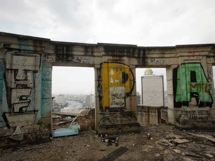 Other inhabited buildings are visible through cement doorways.