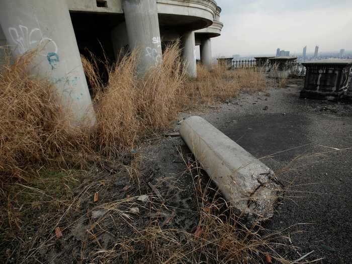 Much of the balcony is overgrown with weeds.