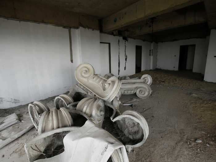 Decorative columns sit in a heap on the floor.