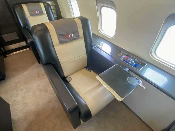 Standard amenities include a foldable tray table stored in the armrest that can be extended half-way for drinks…