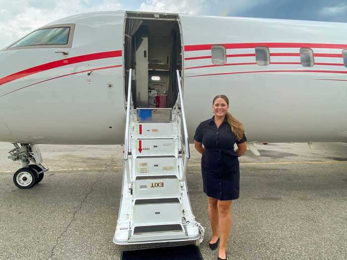 Waiting at the bottom of the air-stairs is the cabin attendant, greeting each passenger as they board.