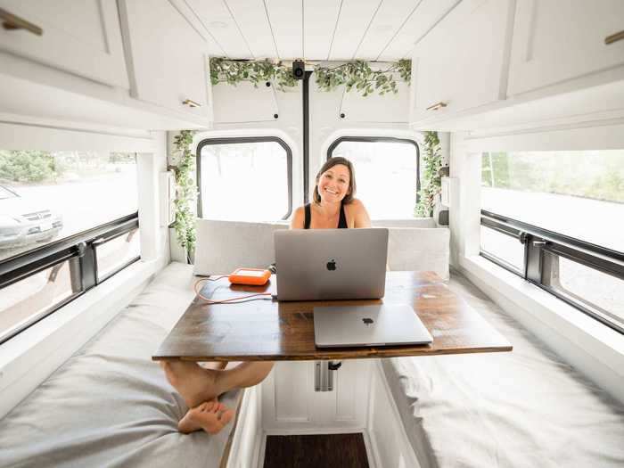 To accommodate their work station, Kara and Nate bought a van with a convertible bed.