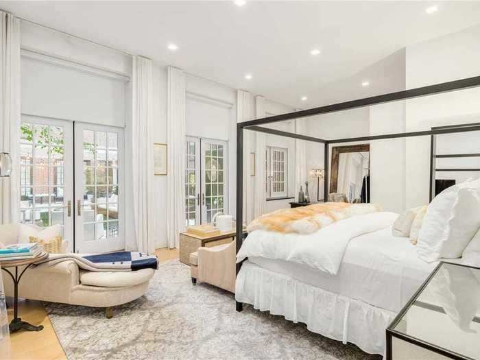 The master bedroom features large French doors that open to a terrace.