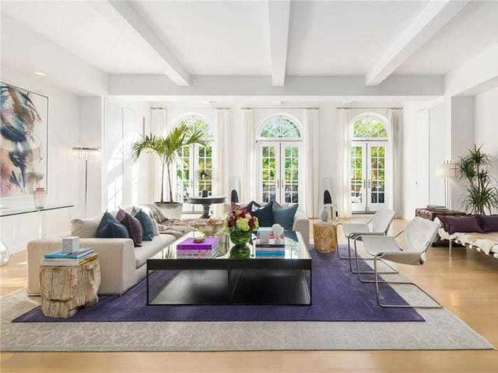 The apartment features large windows overlooking Madison Square Park.