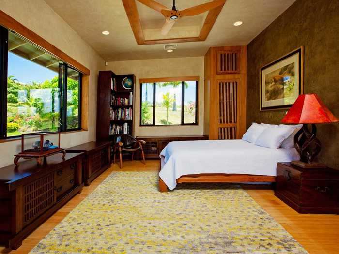 Each of the five bedrooms features wood paneling and multiple windows.