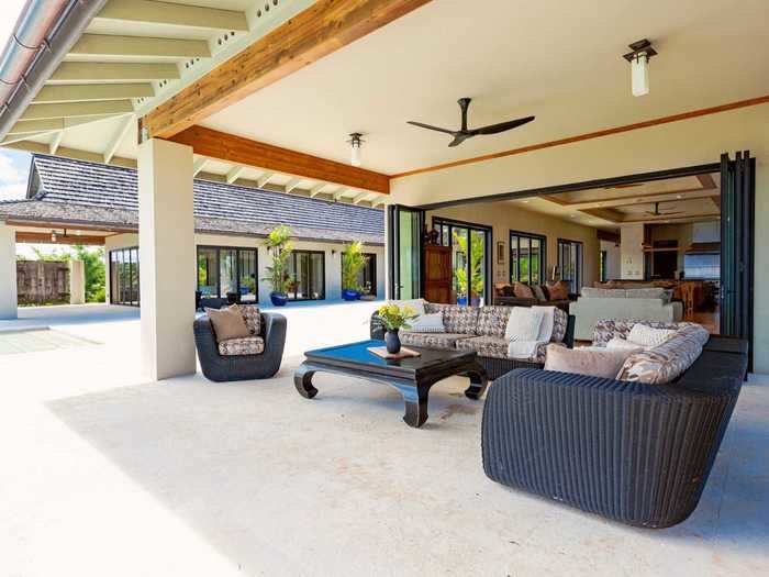 Folding glass doors open up the home to the outside.