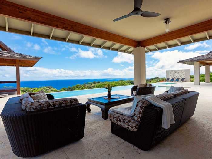 Covered and outdoor seating areas line the perimeter of the pool.