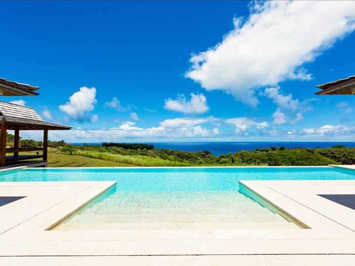 ... opening up to a vivid turquoise saltwater pool and views of the ocean.