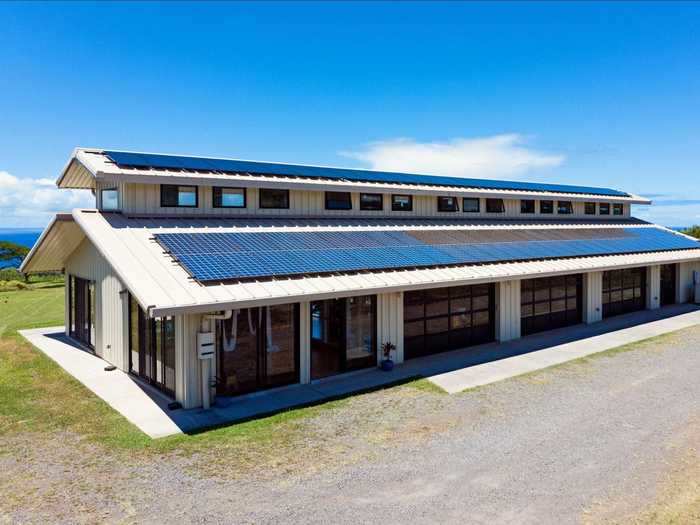 Covered in 96 solar panels with a water cachement system and a generator, the barn provides power for the property.