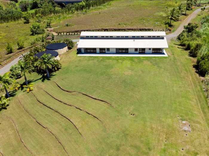 The first building is a 4,000-square-foot barn, home to a five-car garage, fitness center, and two-bedroom 