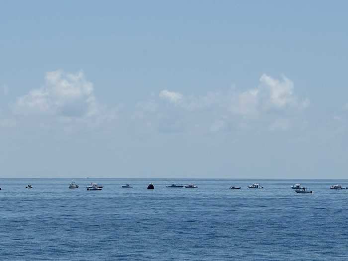 SpaceX and NASA teams in speedboats rushed to recover the capsule and pull the astronauts out — but civilian onlookers in their own boats swarmed the scene, too.