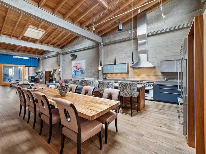 Metallic details and hanging light fixtures continue the industrial vibe throughout the main living space.