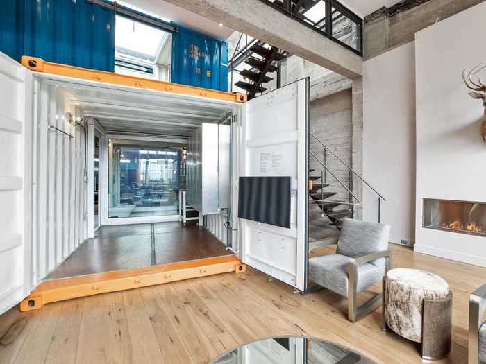 With open doors, the custom shipping containers look intentional and blend into the home.