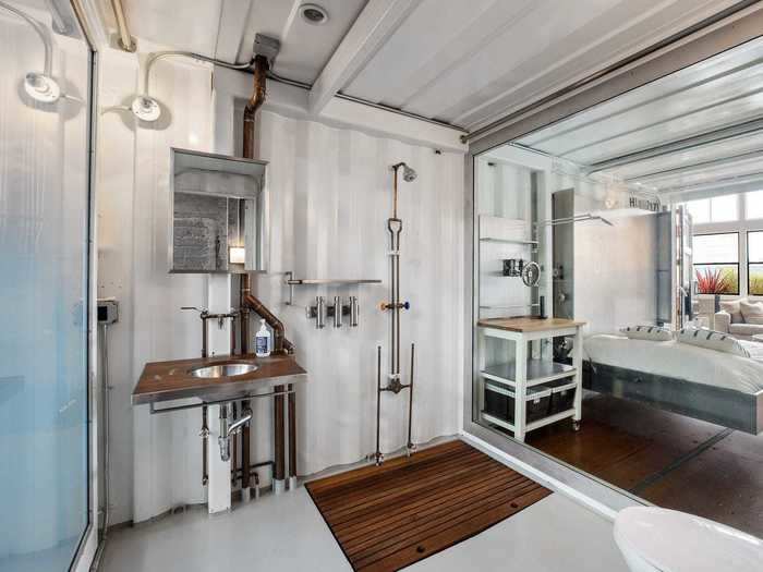 The "privacy wall" for the guest bathroom goes from clear to opaque based from a switch. The former owners told Dwell that the bathroom was designed to be reminiscent of a ship or train.