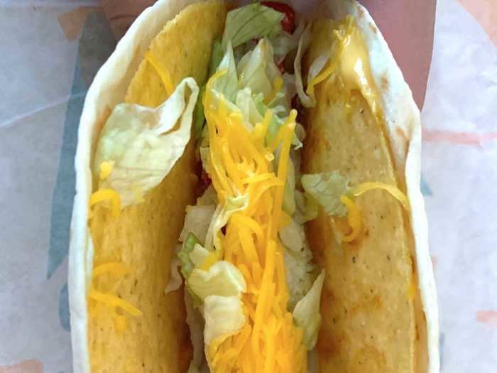 I examined the taco and saw that the tortilla and hard shell were held together by some nacho cheese sauce.