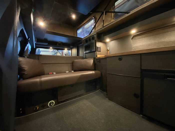 One of the possible floor plans includes a television-side dinette by the front of the van that can be converted into a bed. In this floor plan, the kitchen, closet, and storage cabinets are all in the middle to rear of the van.