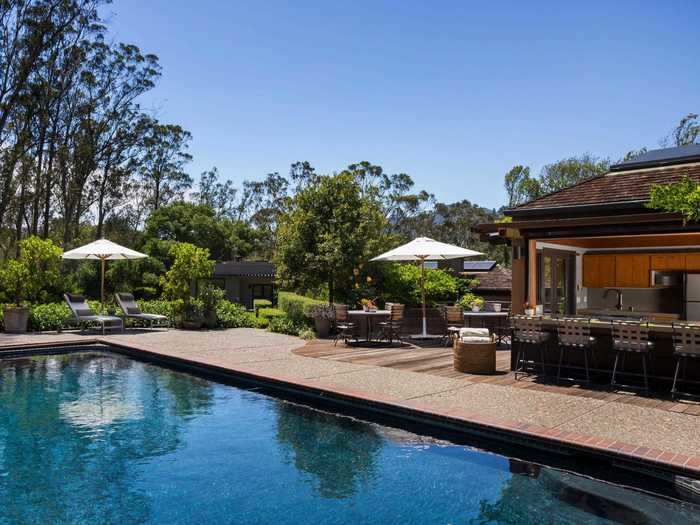 Next to the outdoor swimming pool is a pool cabana with its own kitchen and half bathroom.