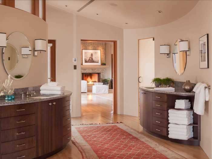 The attached master bathroom includes dual dressing areas ...