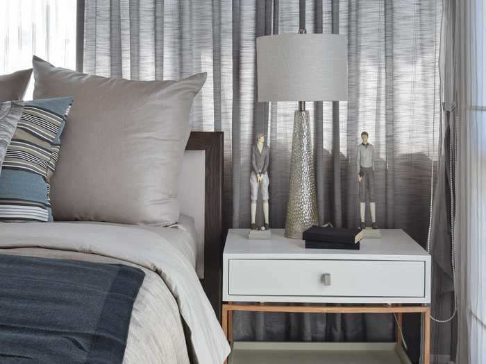 You might not want to keep a lamp on your nightstand. Instead, try a wall sconce or hanging light.