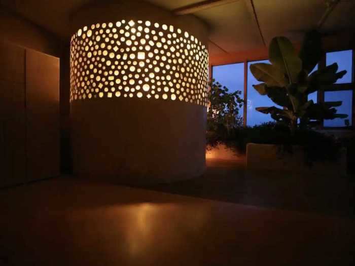 As the sun sets, the curved bathroom illuminates the entire home.