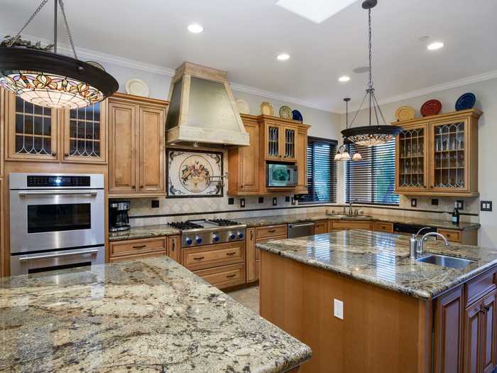 The kitchen comes with "double" everything: There are two ovens, two islands, two fridges, and two dishwashers.