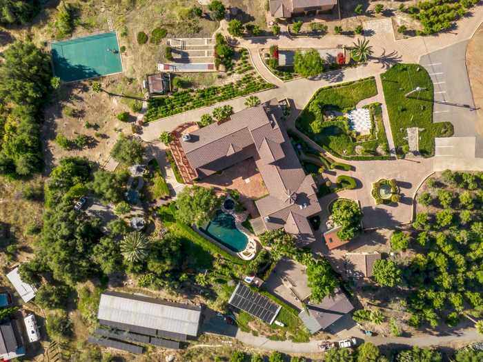 In addition to the eight-bedroom main house, the property includes two green houses, a garage covered in solar panels, and a dizzying number of recreational facilities.