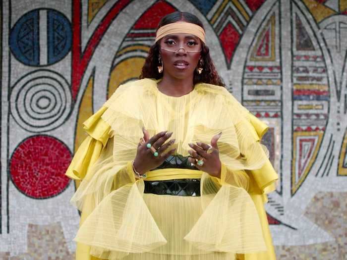 Tiwa Savage performs "Keys to the Kingdom," draped in yellow and framed by geometric patterns.