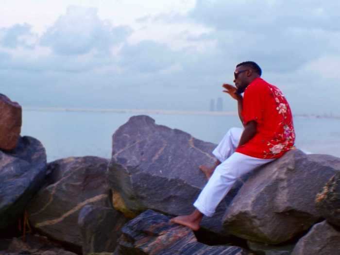 Cameroonian artist Salatiel is filmed by the shore during his performance of "Water."