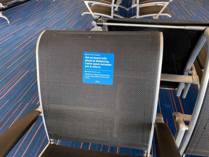 Social distance placards were placed on the floor at the gate and even on chairs throughout the seating area...