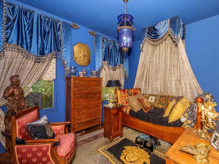 There are three bedrooms, each with a different look. This one takes on a Moroccan vibe with bold colors and gilded accents.