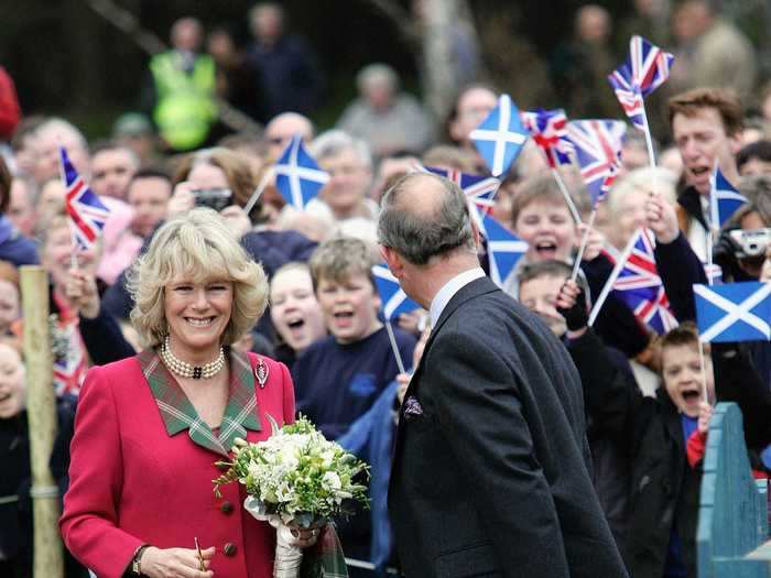 Charles and Camilla — known in Scotland as the Duke and Duchess of Rothesay — spent their honeymoon at the estate. This photo shows the couple taking some time away from their romantic getaway to open a local children