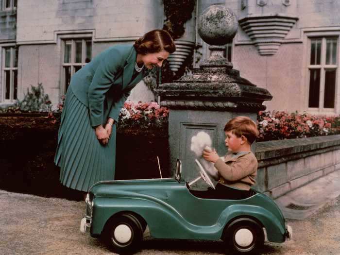 They enjoyed plenty of candid moments too. In this photo, the Queen plays with a 4-year-old Prince Charles.