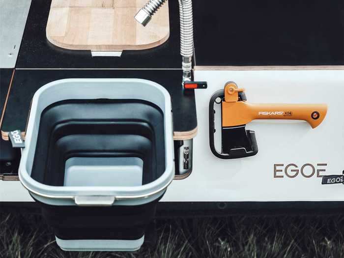 The kitchen portion has a removable gas stove and a sink that sources its water from a 12-volt electric pump and 4.76-gallon water tank.