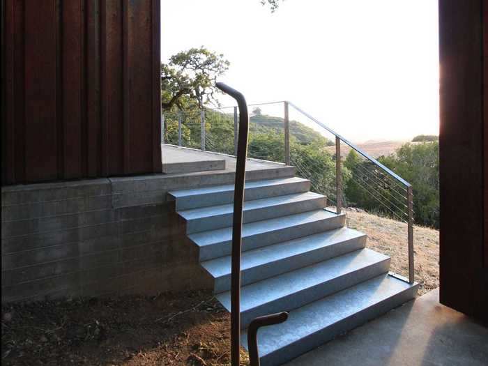 The two buildings are connected by steel stairs and railings, also designed by Alchemy.