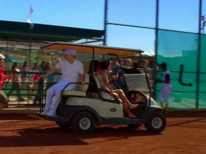 Taylor and Gabriella drive a golf cart onto the Lava Springs baseball field, even though Gabriella