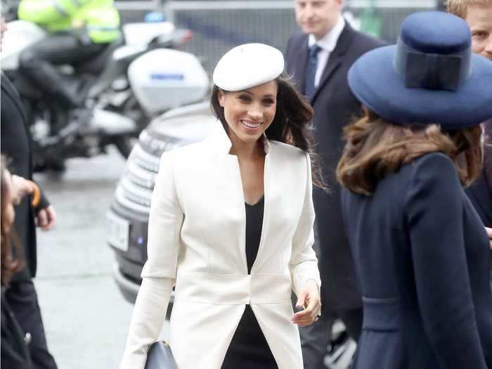 Markle wore a coat designed by Amanda Wakely and a hat by Stephen Jones to a Commonwealth Day service.