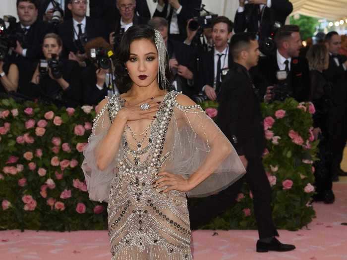 Constance Wu appeared at the same event wearing a sheer embroidered dress with a plunging neckline.