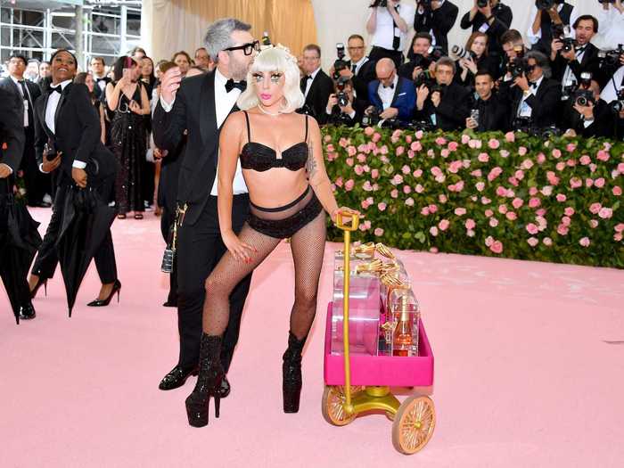 Lady Gaga arrived in a grand way to the Met Gala in a giant pink dress, which she removed to reveal multiple outfits beneath.