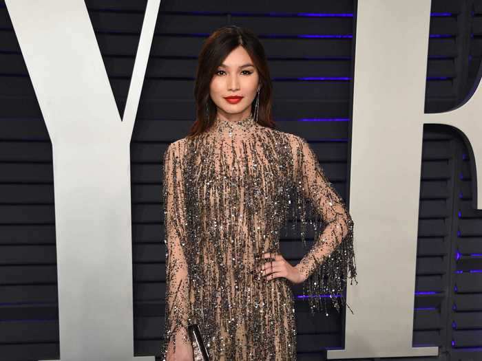 Gemma Chan wore a semi-sheer dress with metallic fringe embellishments on top.