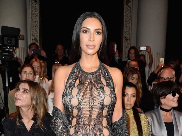 And then Kim rocked this netted sheath dress for the Balmain show at Paris Fashion Week 2016.