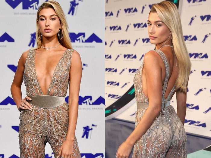 Hailey Baldwin wore a silver jumpsuit in a super thin material with a low V-neck and wide velvet belt to the VMAs in 2017.