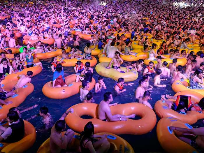 Crowds have poured in throughout the summer, where thousands cool off in a giant swimming pool — sans masks.