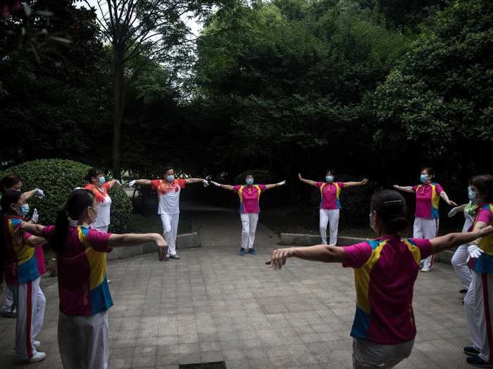 Local residents — still wearing masks — exercised together outdoors.