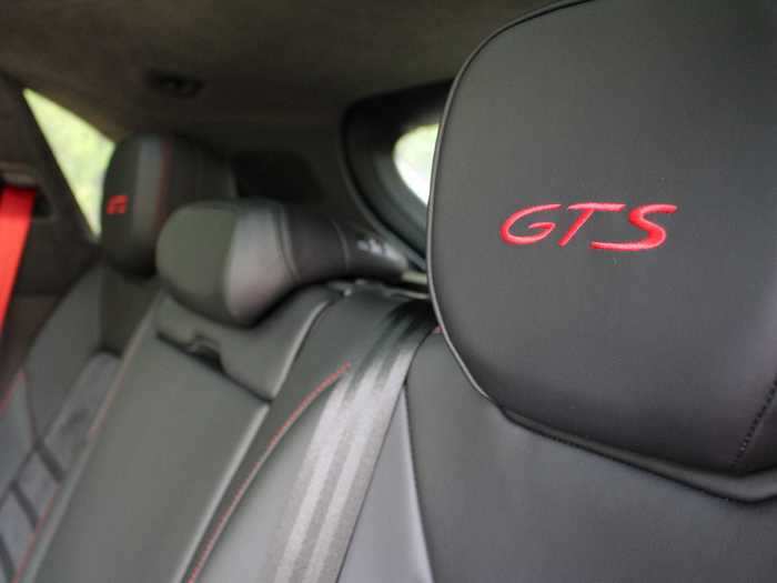 Carmine red topstitching on the black leather seats matches the exterior, as does the GTS call-out. (The seats are comfy for cruising, yet sufficiently bolstered for spirited driving.)