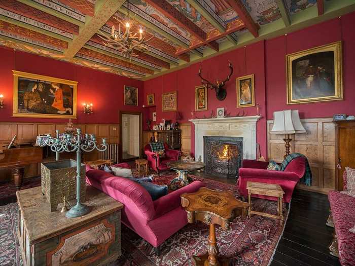 The Great Hall is particularly striking, with an open fireplace, wooden paneling, and medieval painted ceiling, plus three window seats overlooking the front lawns.