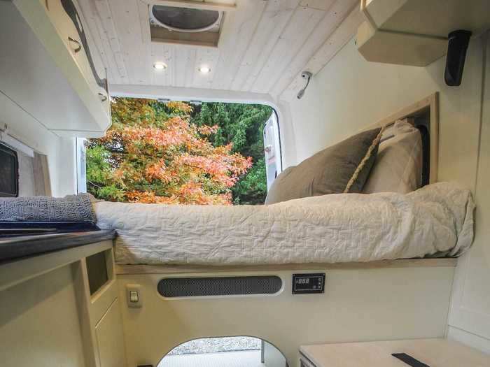 The van has a bed, a kitchen, and a pull-out composting toilet.