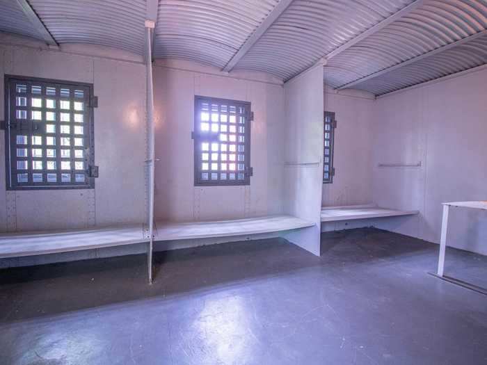 Many of the cells feature barred windows, letting in natural light.