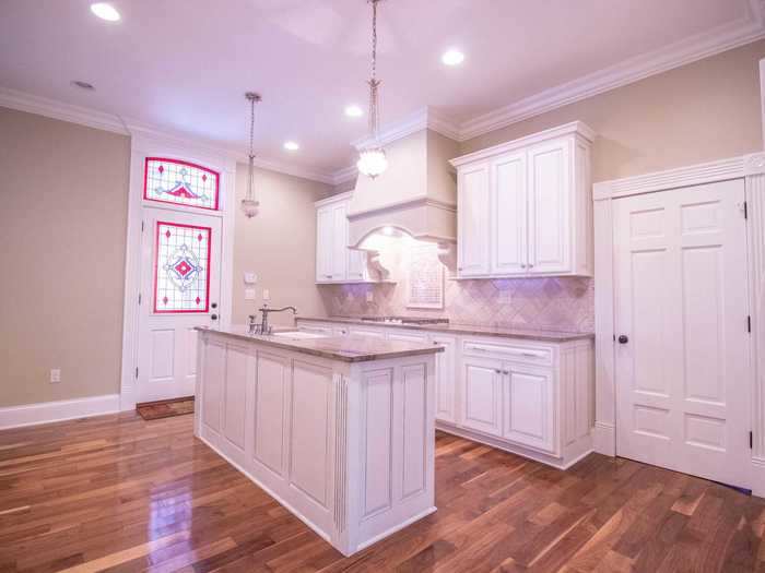 Back downstairs, the kitchen comes with stained glass windows and a kitchen island.