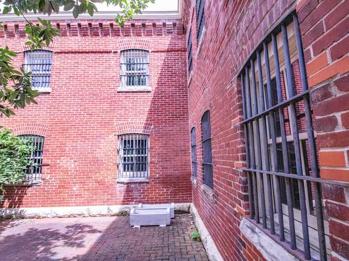 Barred windows around the side of the building hint at its past as a county jail. Built in 1875, the house served as the Howard County Sherriff