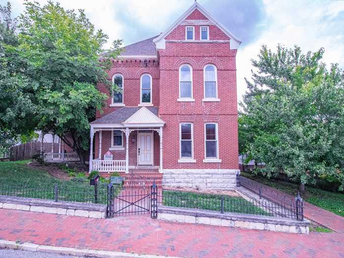 A house complete with an electric fireplace, a clawfoot tub, and nine jail cells is on the market for $350,000.